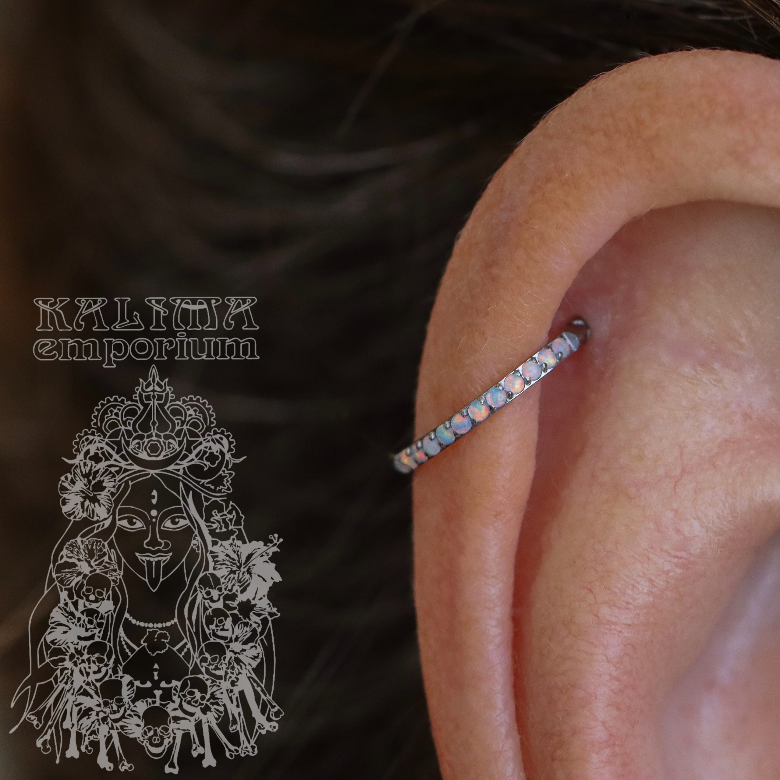 Helix piercing with white opal paved hinged ring